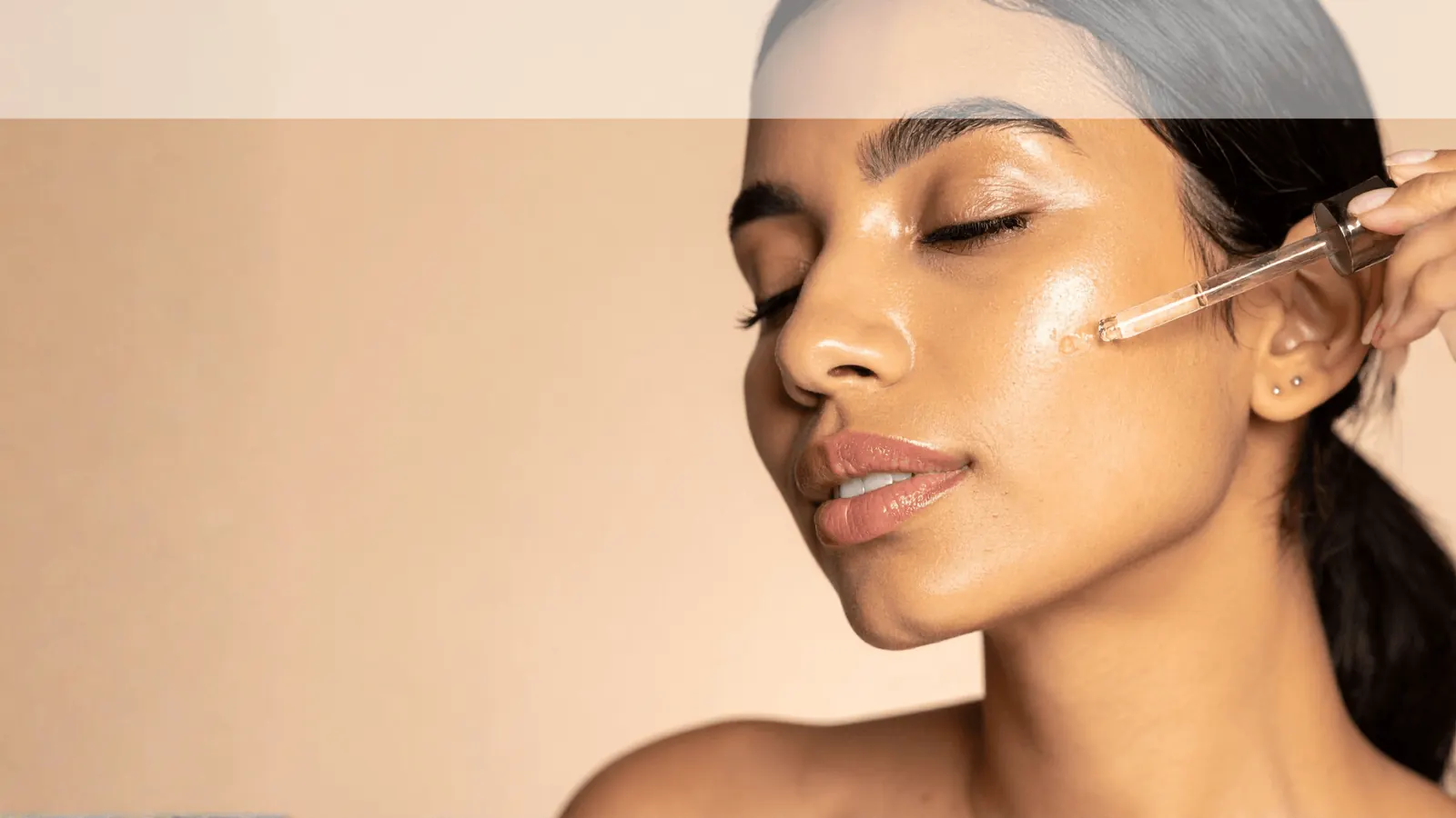 Applying argan oil to the face